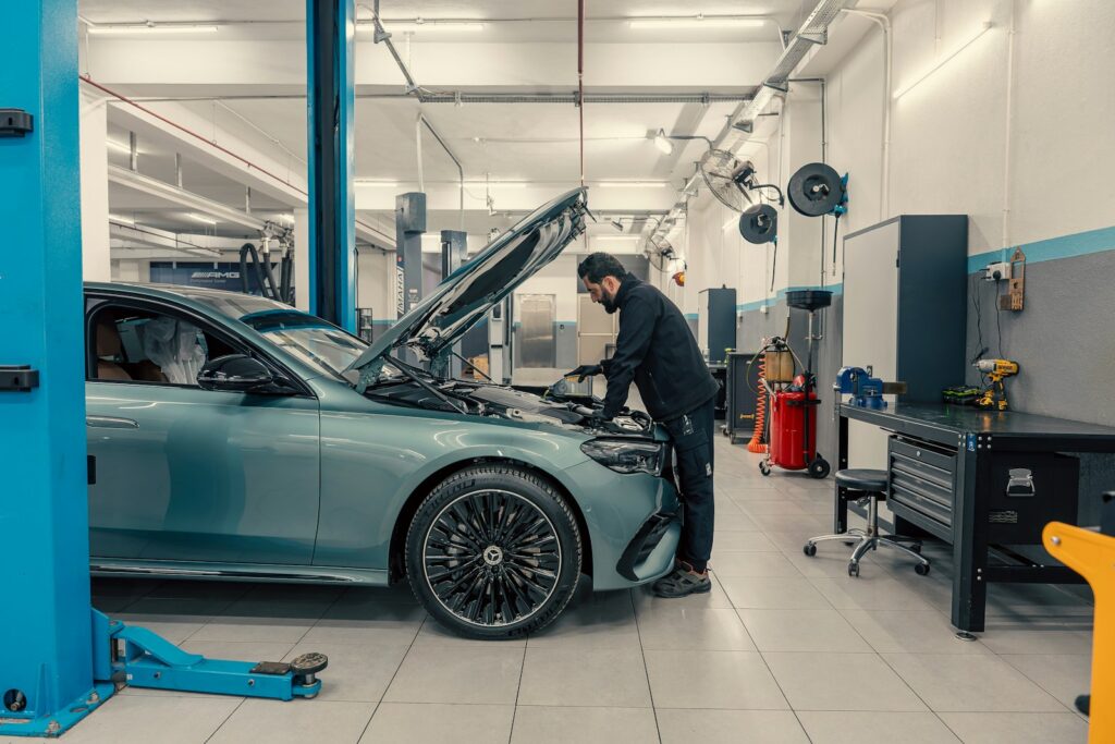 Mechanic working on a car engine in a workshop