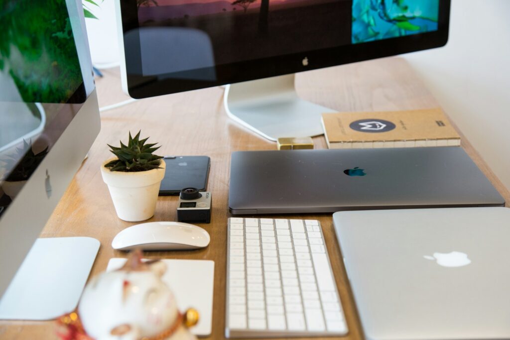 A wooden desk topped with a computer monitor and keyboard